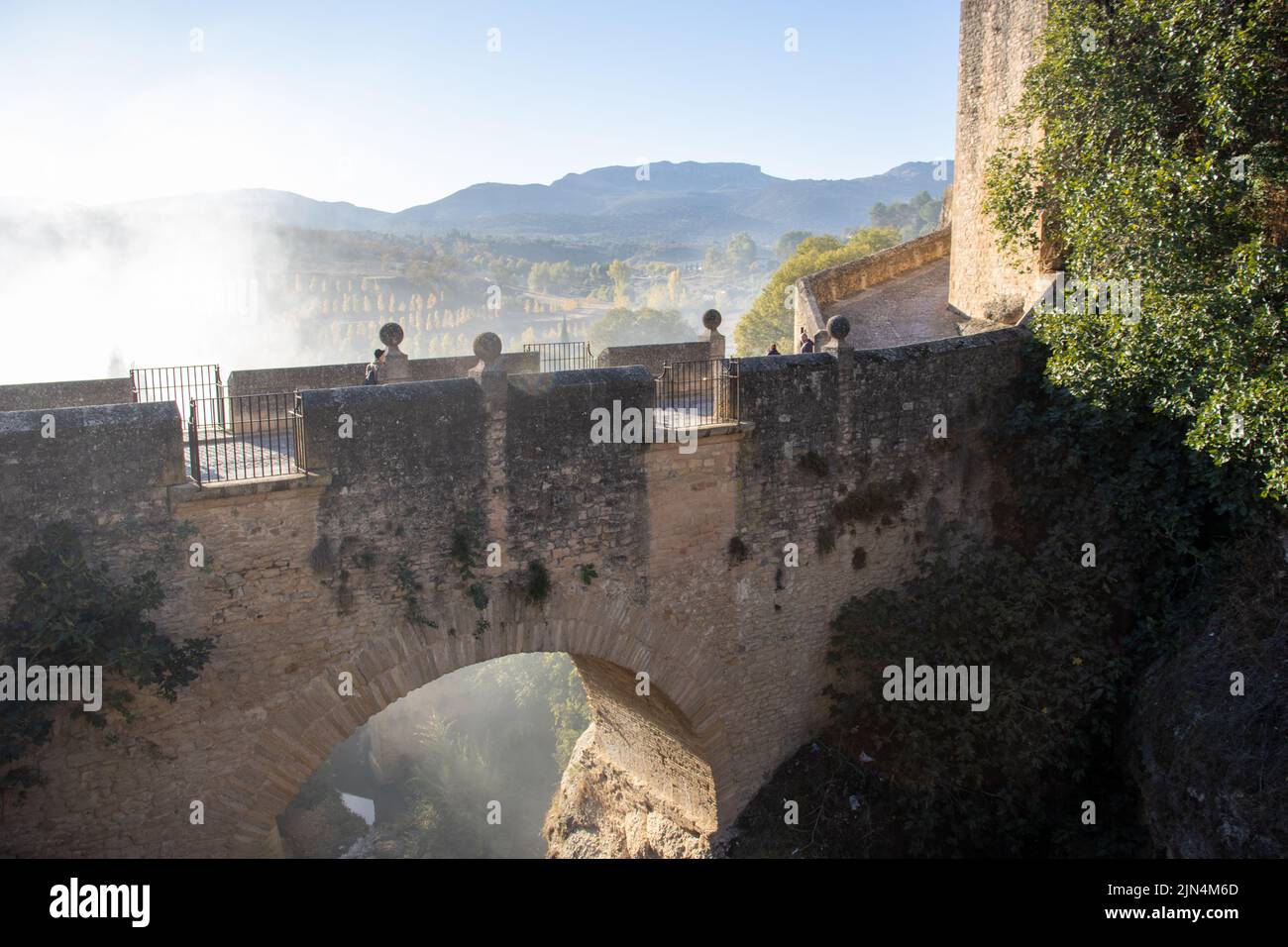 RONDA, ANDALUSIA, SPAIN - NOVEMBER 5,  2021 close up of the Old Bridge in the morning light and mist rising Stock Photo