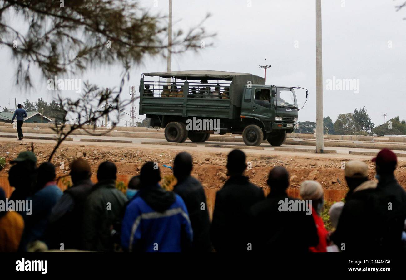 A police truck patrols as voters queue before casting their ballots during the general election by the Independent Electoral and Boundaries Commission (IEBC) in Mashimoni village of Kibera slums of Nairobi, Kenya August 9, 2022. REUTERS/Thomas Mukoya Stock Photo