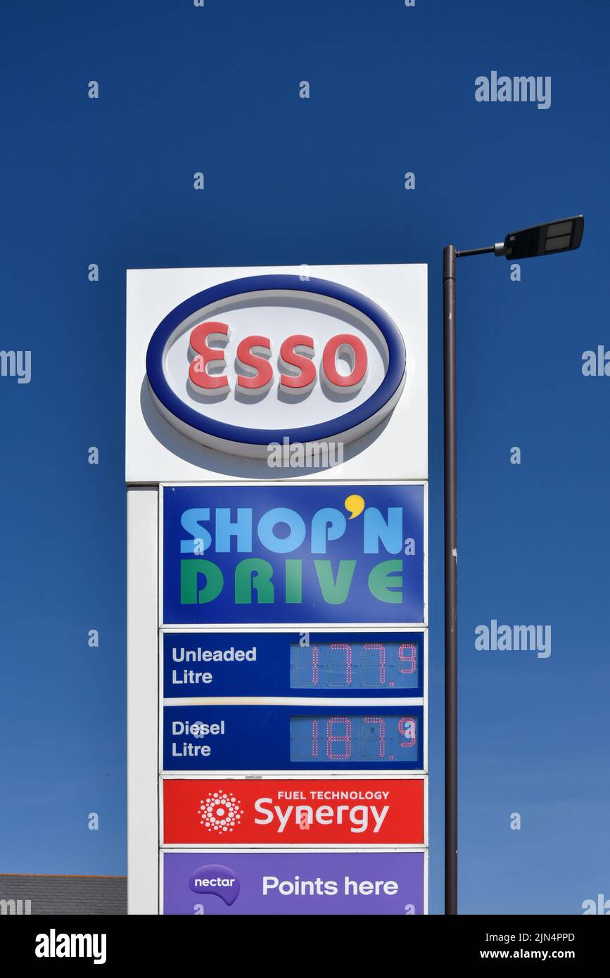 Esso petrol station sign in Portsmouth showing current UK fuel prices and other services. August 2022. Stock Photo