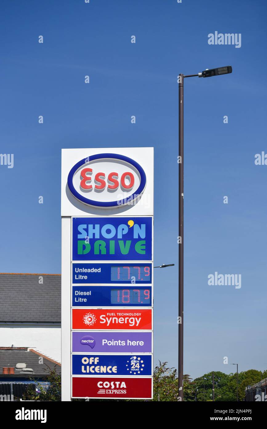 Esso petrol station sign in Portsmouth showing current UK fuel prices and other services. August 2022 Stock Photo