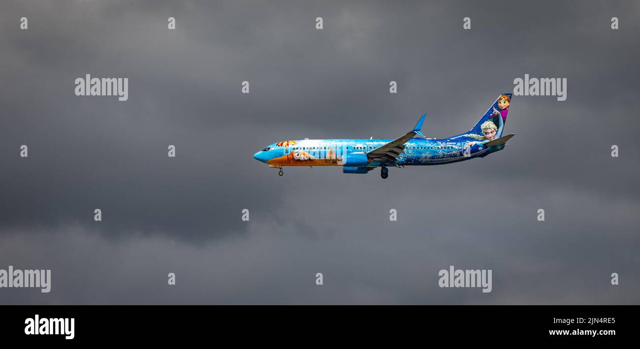 West Jet Airlines Airplane in the overcast sky. WestJet is a Canadian low-cost carrier and second-largest, behind Air Canada. WestJet plane Frozen the Stock Photo