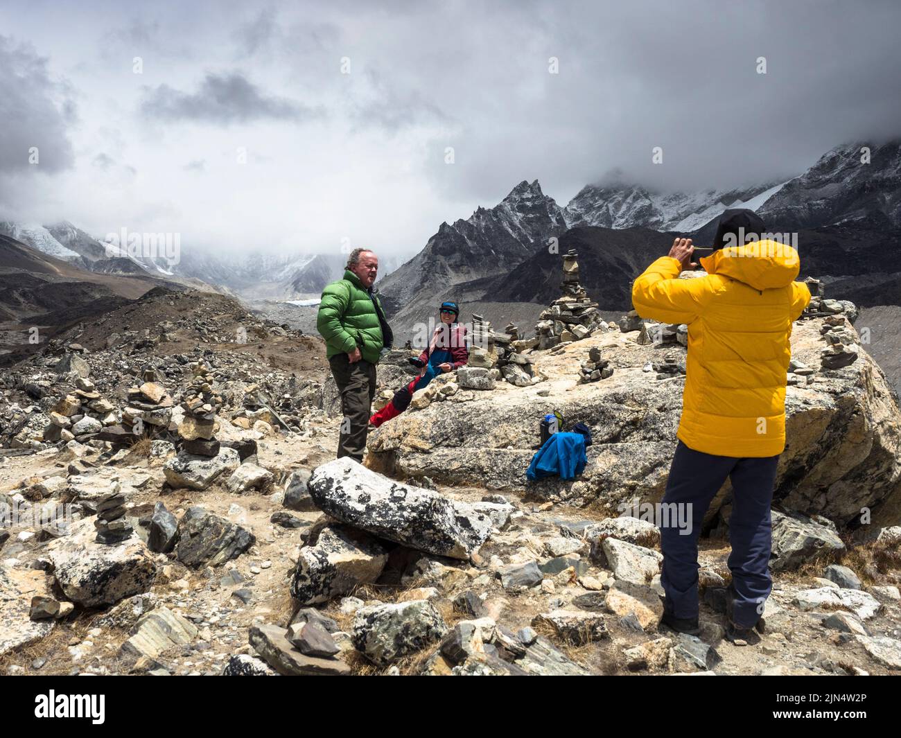 Trekkers posing on the morain above the Khumbu Glacier near Lobuche on the Everest Base Camp trek, Nepal. Stock Photo