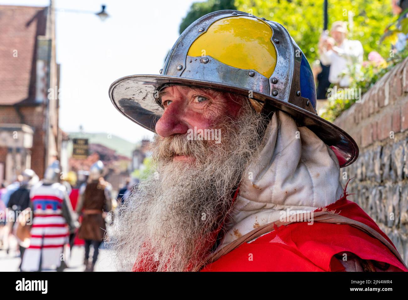 A Man Dressed In Medieval Costume Prepares To Take Part In A Re-Enactment Of The Battle Of Lewes , Lewes, East Sussex, UK Stock Photo