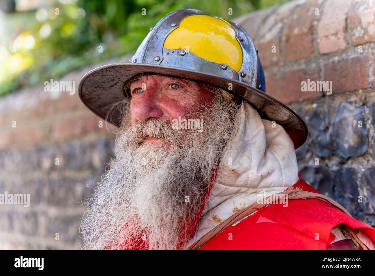 A Man Dressed In Medieval Costume Prepares To Take Part In A Re-Enactment Of The Battle Of Lewes , Lewes, East Sussex, UK Stock Photo