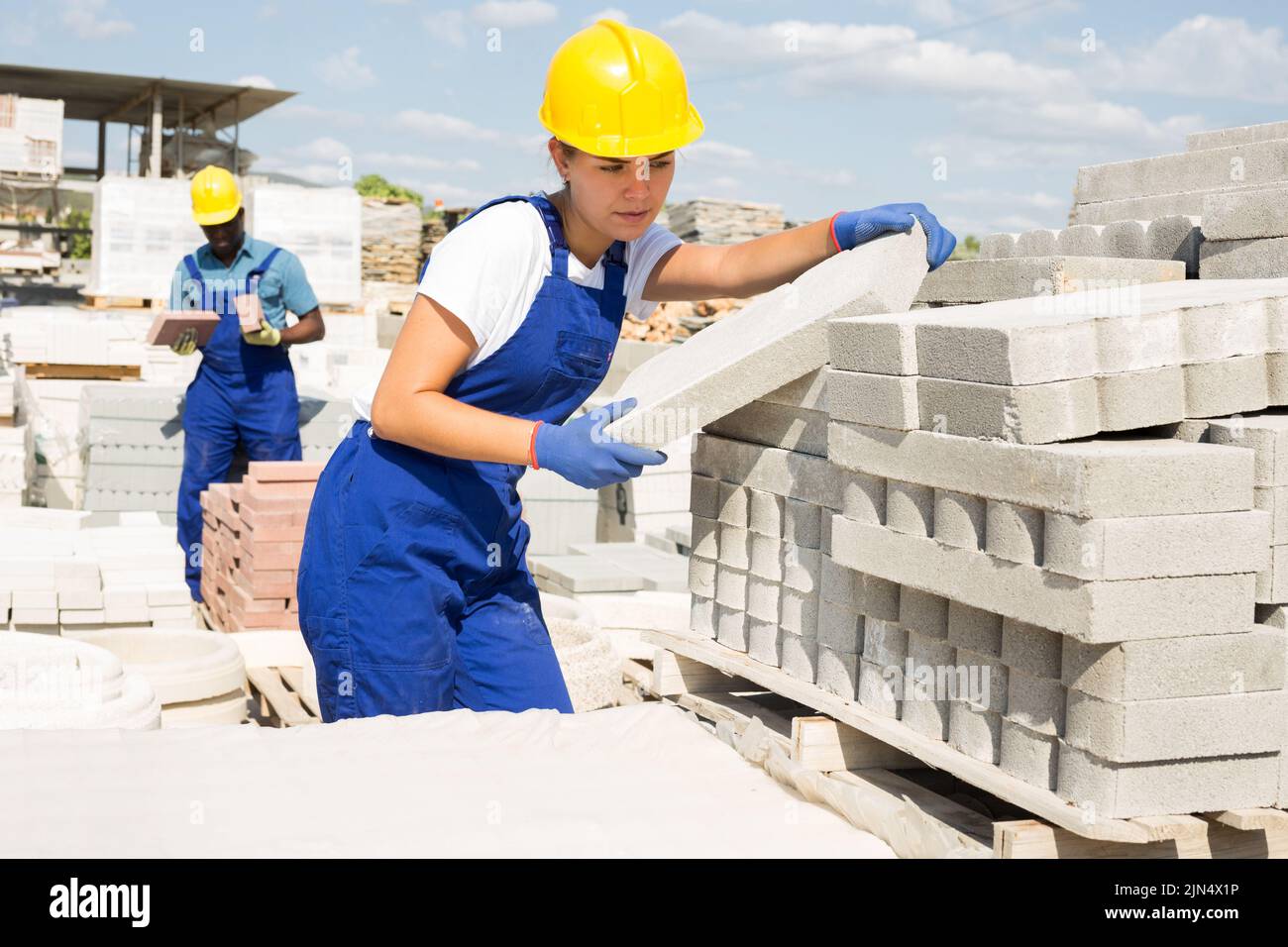 Man and woman working in construction material storage Stock Photo