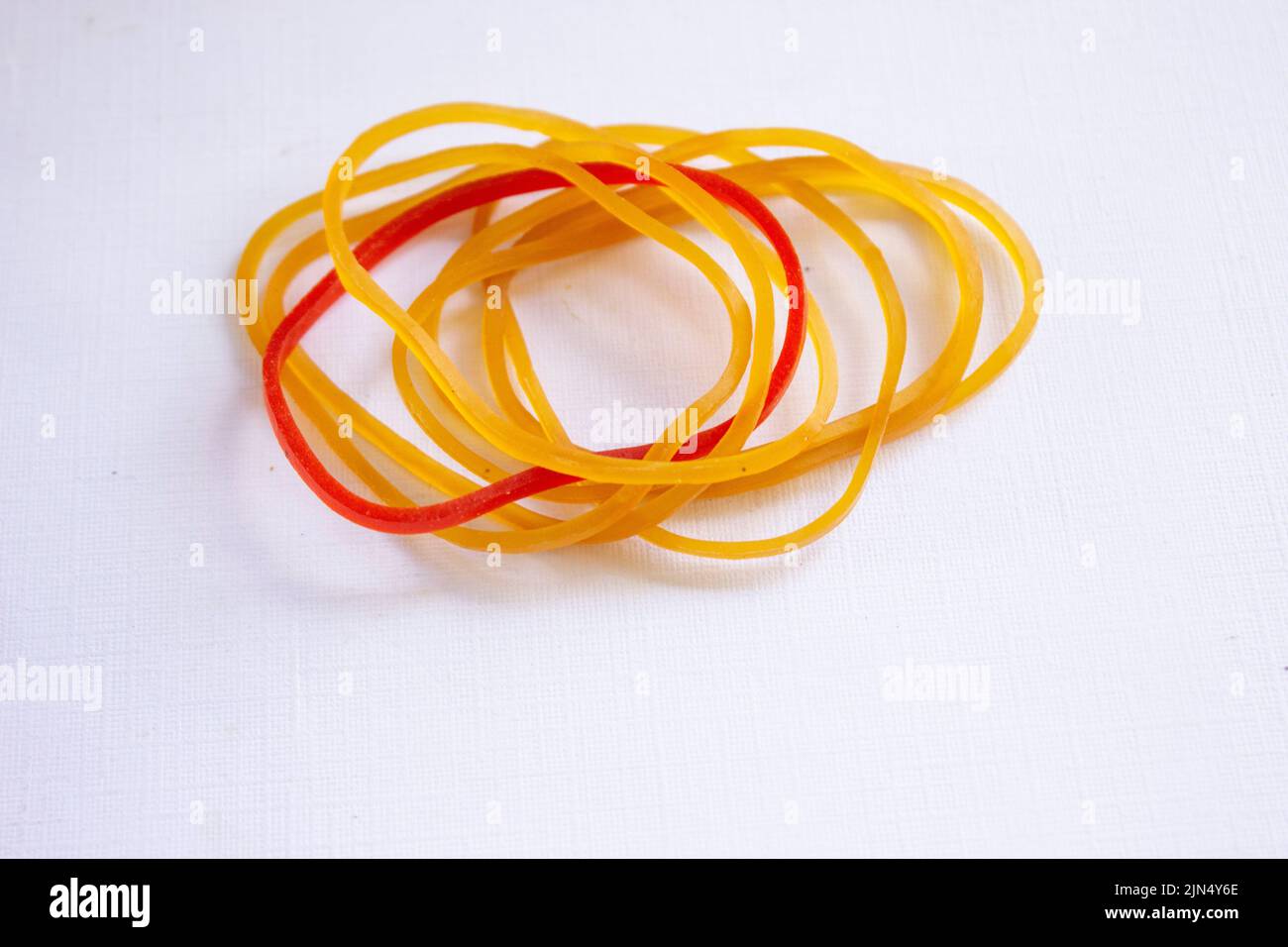 Red rubber band. Elastic bands. dragging an elastic band, isolated on white background Stock