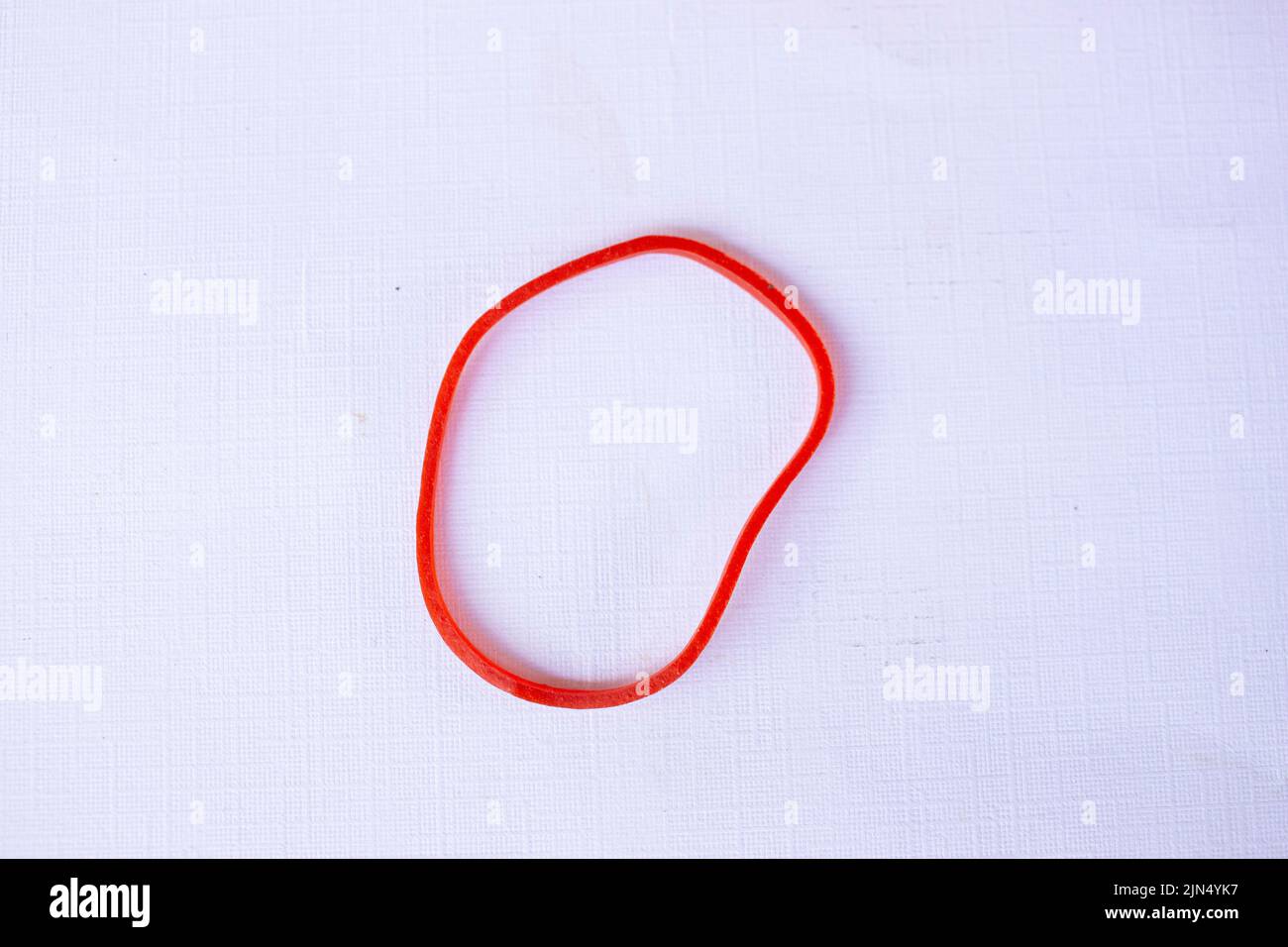 Red rubber band. Elastic bands. dragging an elastic band, isolated on white background Stock