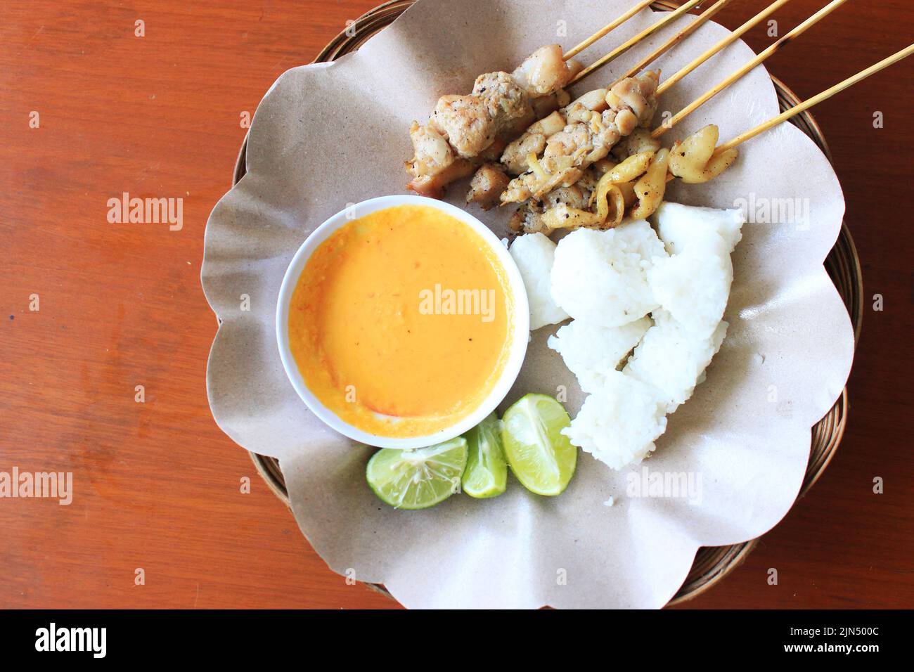 sate taichan or taichan satay , made from chicken meat, served with Sauce, Ketchup and lime. this food like yakitori Stock Photo