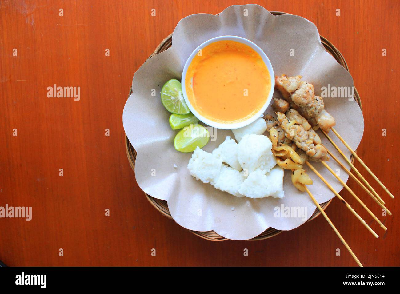 sate taichan or taichan satay , made from chicken meat, served with Sauce, Ketchup and lime. this food like yakitori Stock Photo