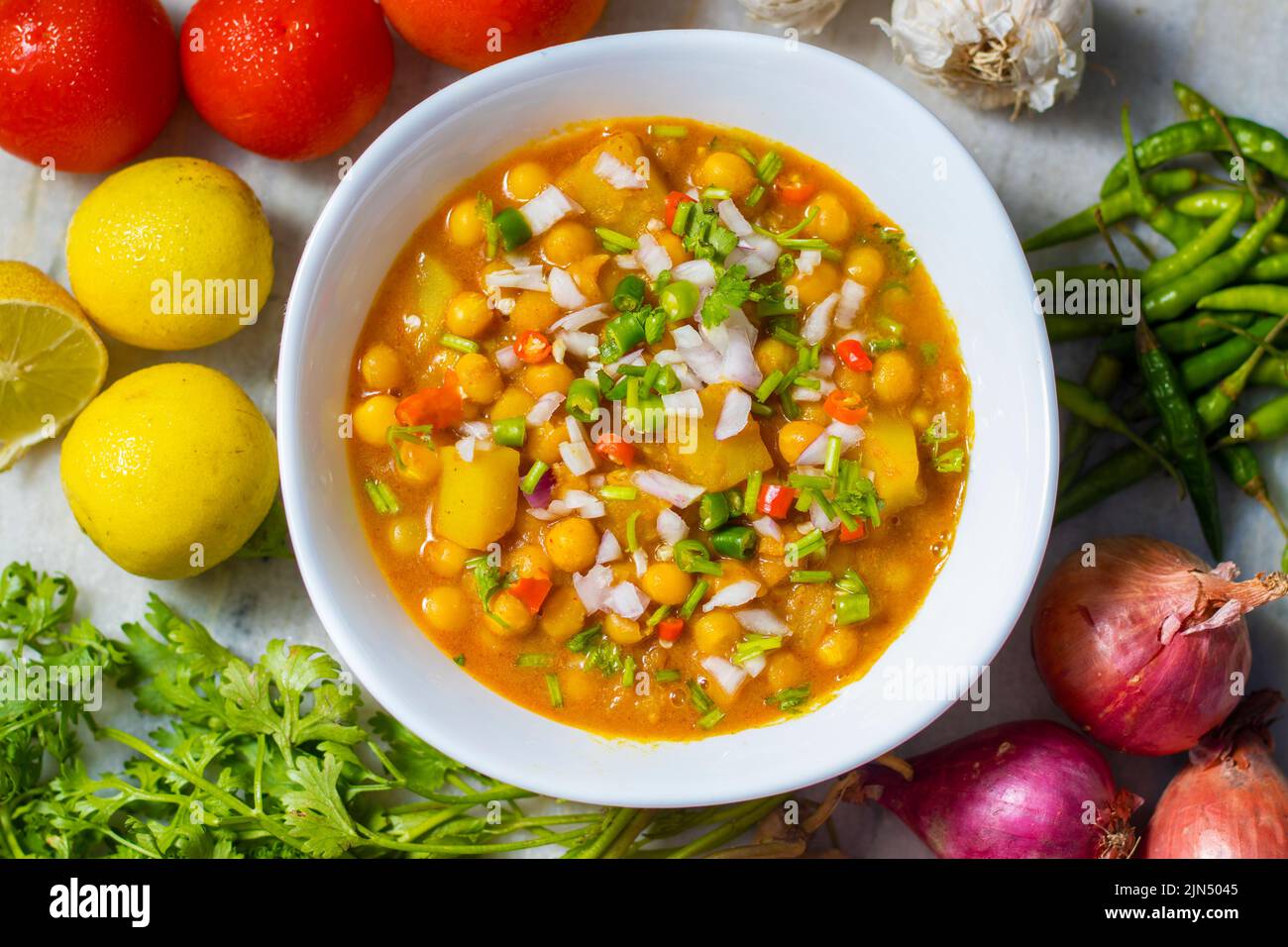 selective focus of delicious Bengali street food "Ghugni" made of chickpeas. with a marble background. Stock Photo