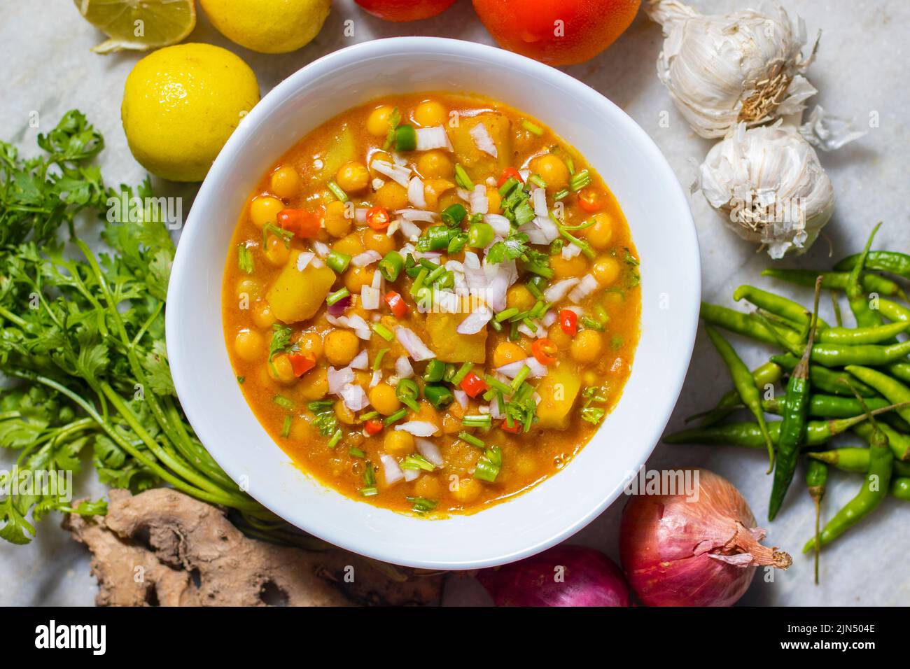 selective focus of delicious Bengali street food 'Ghugni' made of chickpeas. with a marble background. Stock Photo