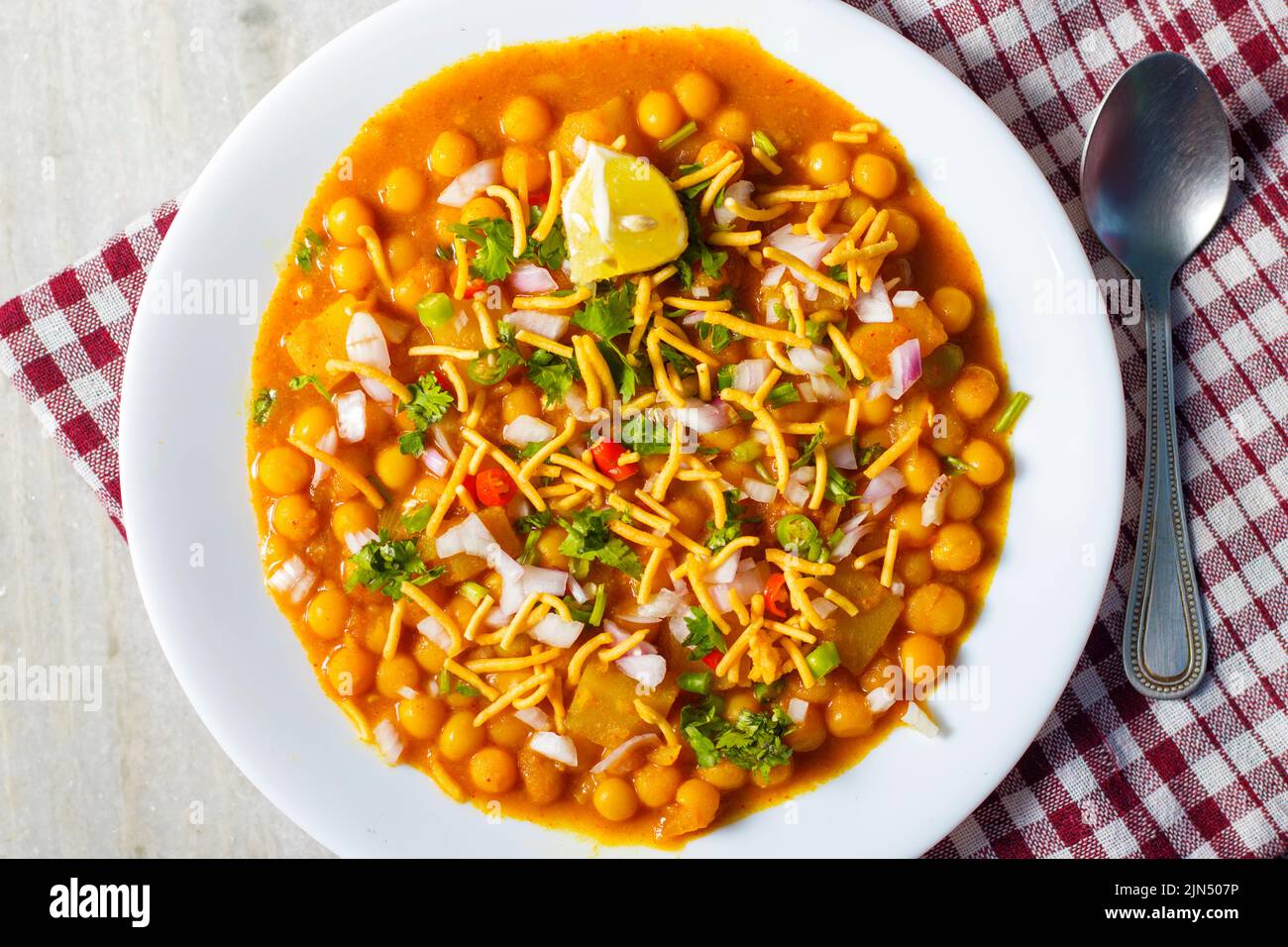 selective focus of delicious Bengali street food 'Ghugni' made of chickpeas. with a marble background. Stock Photo