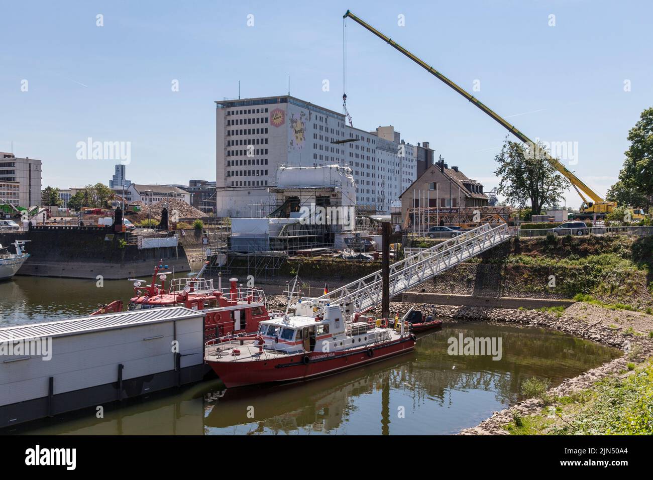 renovation of the swing bridge in the Rhine harbor Deutz, in the background the Ellmill or Aurora mill, fire-fighting boats, Cologne, Germany. Sanieru Stock Photo