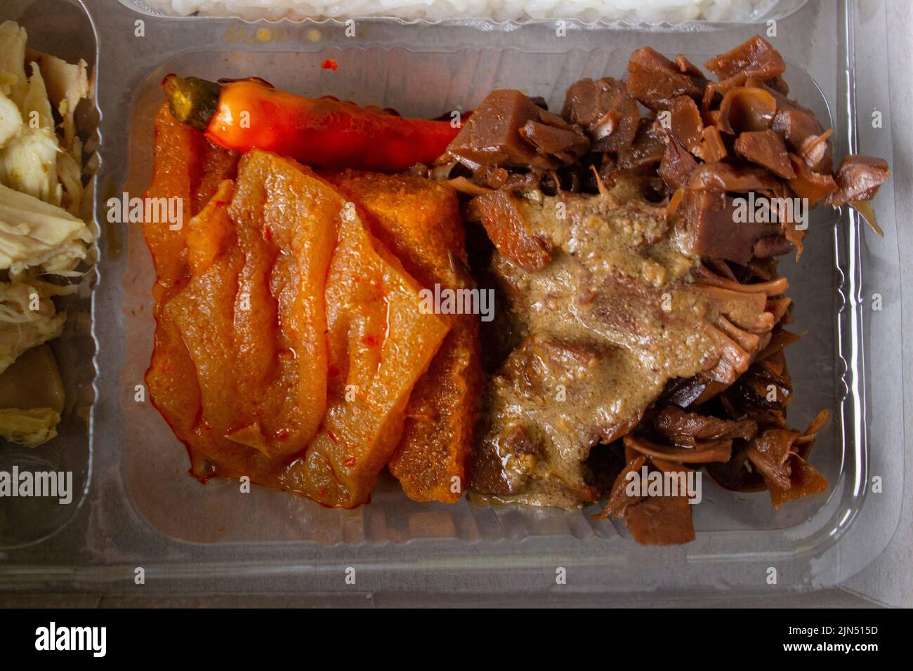 lunch boxes gudeg are similar to Bento boxes - rice boxes, rice, catering boxes, food services (rice warm, sweet eggs, krecek, tofu, tempeh, pieces of Stock Photo