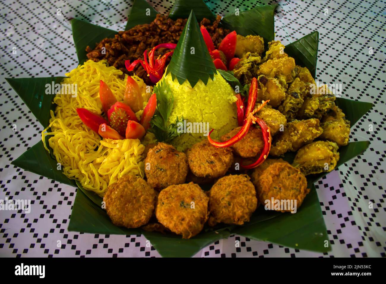 nasi kuning or yellow rice or tumeric rice is traditional food from