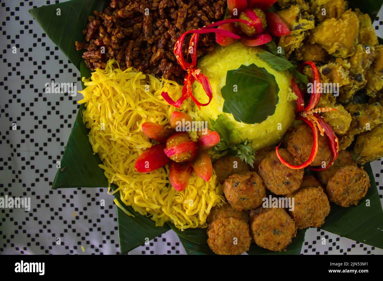 nasi kuning or yellow rice or tumeric rice is traditional food from ...
