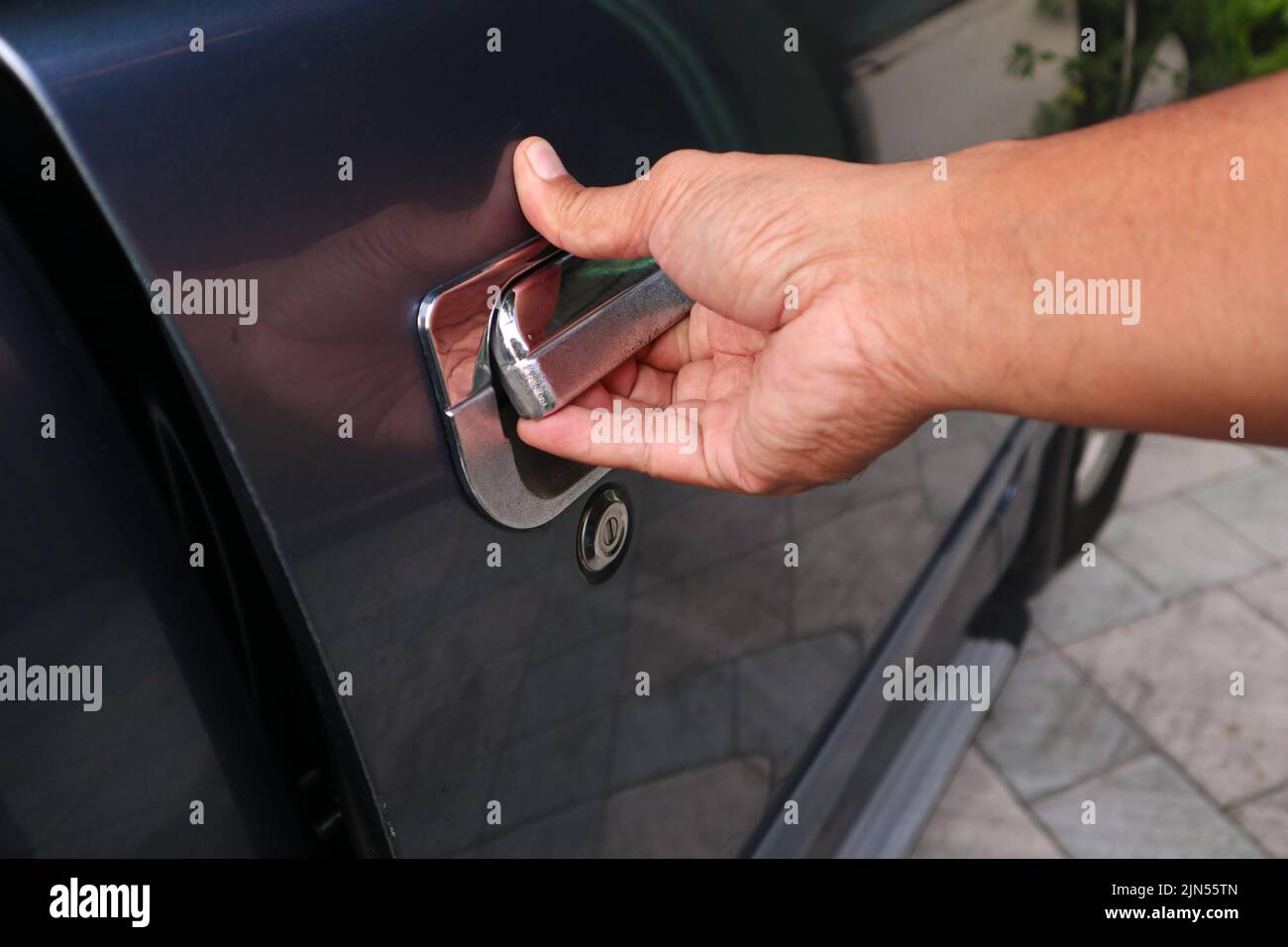 Hand man on handle. Close-up of man in opening a car door Stock Photo
