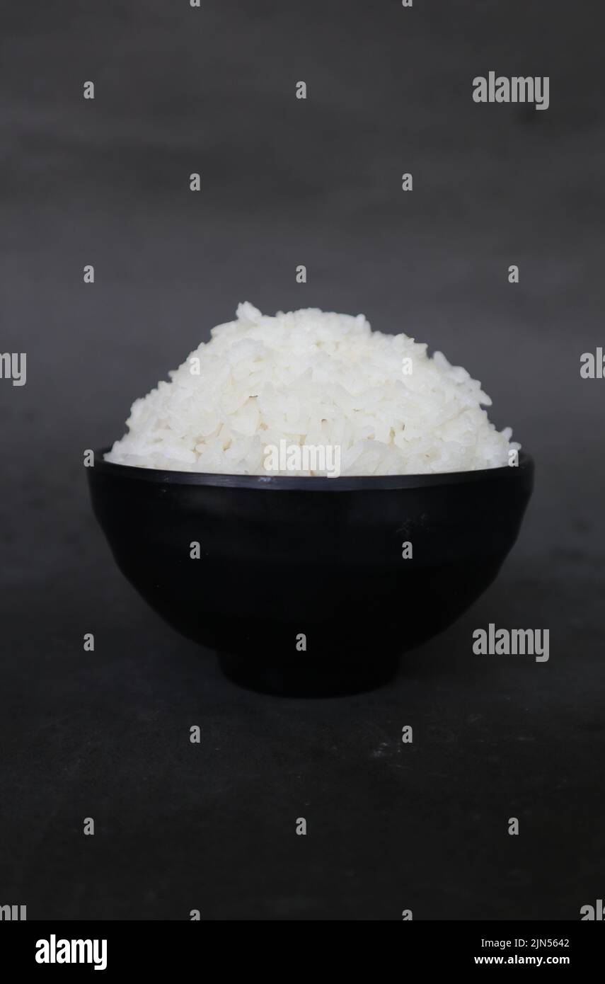 white steamed rice or nasi putih served in little bowl isolated on white background Stock Photo