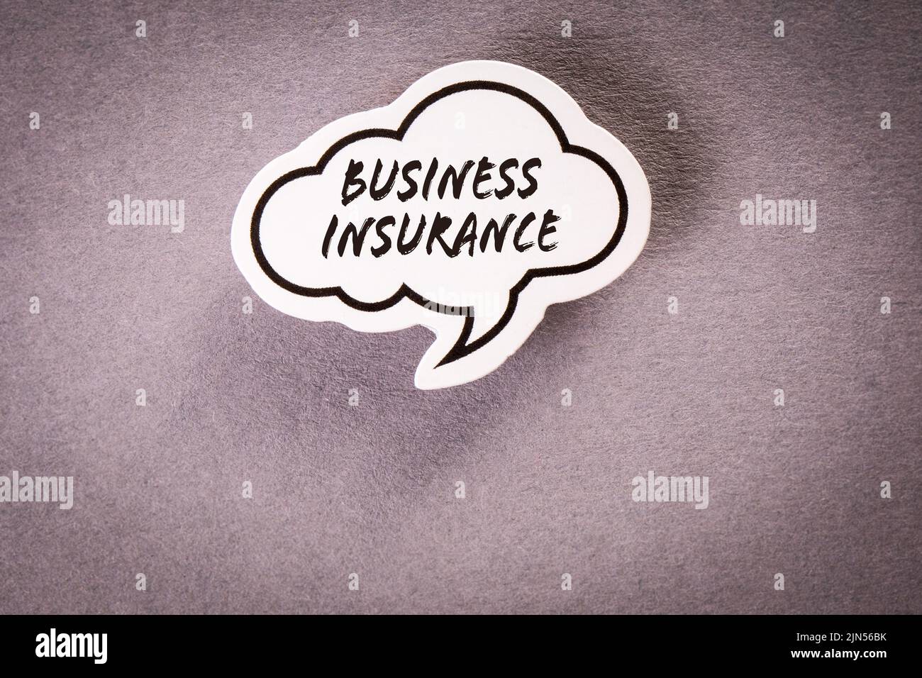Business insurance. Speech bubble with text on gray background. Stock Photo