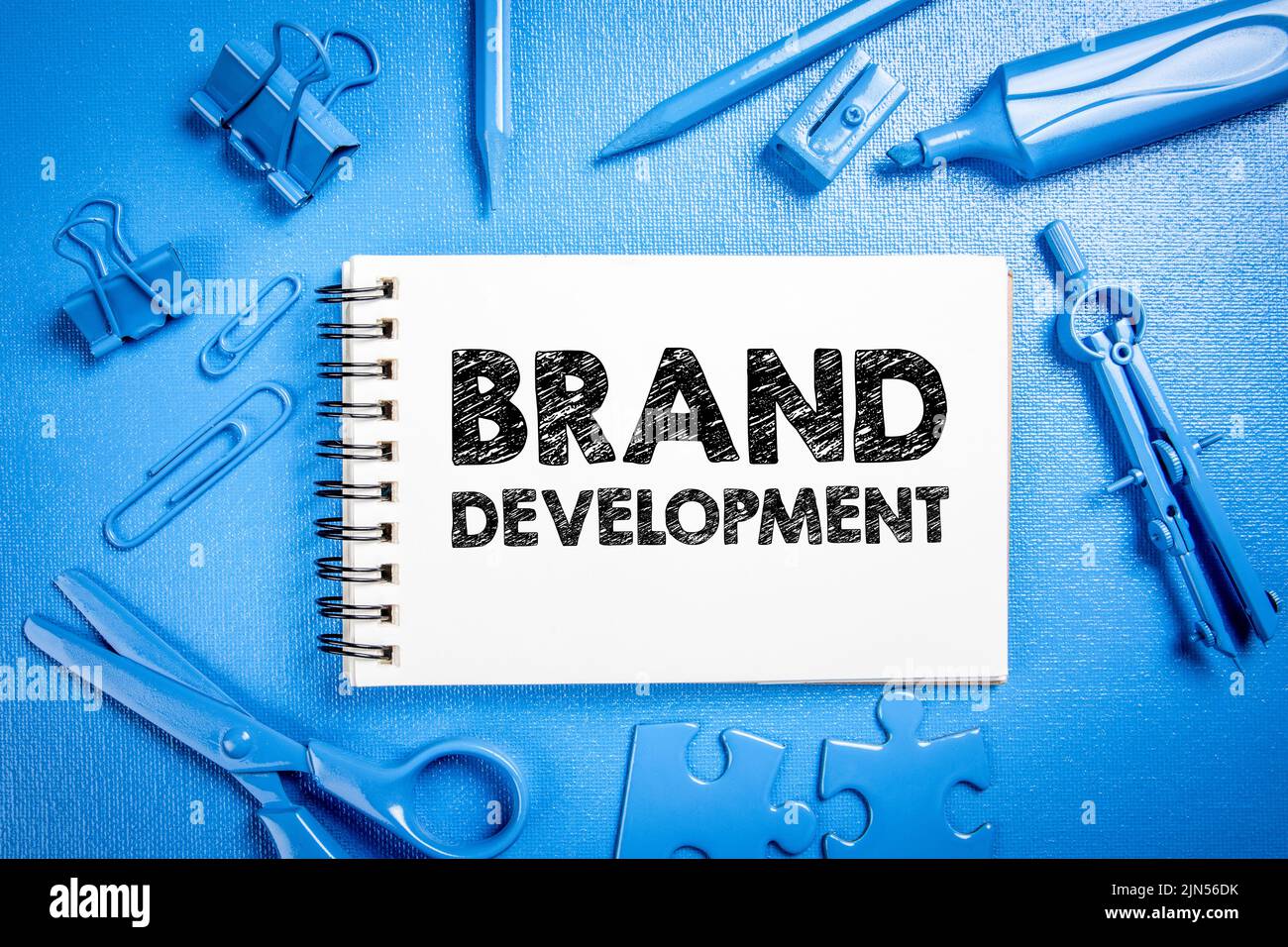 Brand development. Office supplies on a blue textured background. Stock Photo