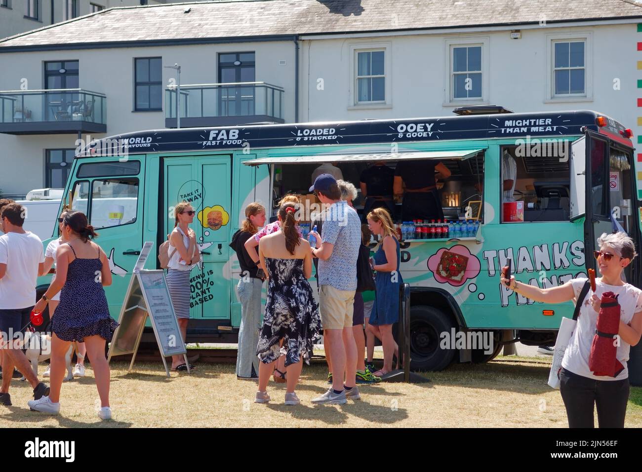 A fast food truck and customers at the beach bbq festival in Bray