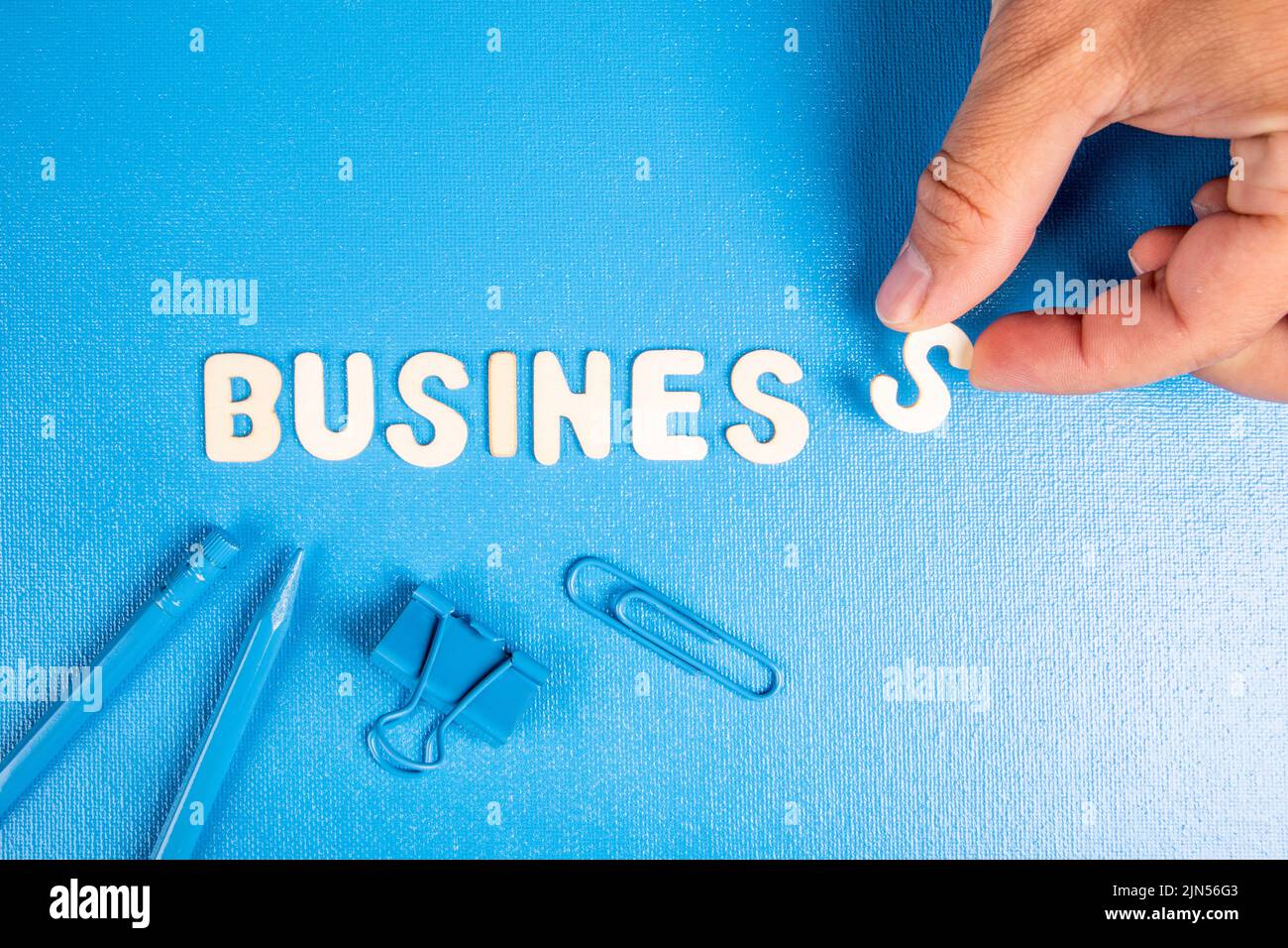 Business. Text from white wooden letters on a blue background. Stock Photo