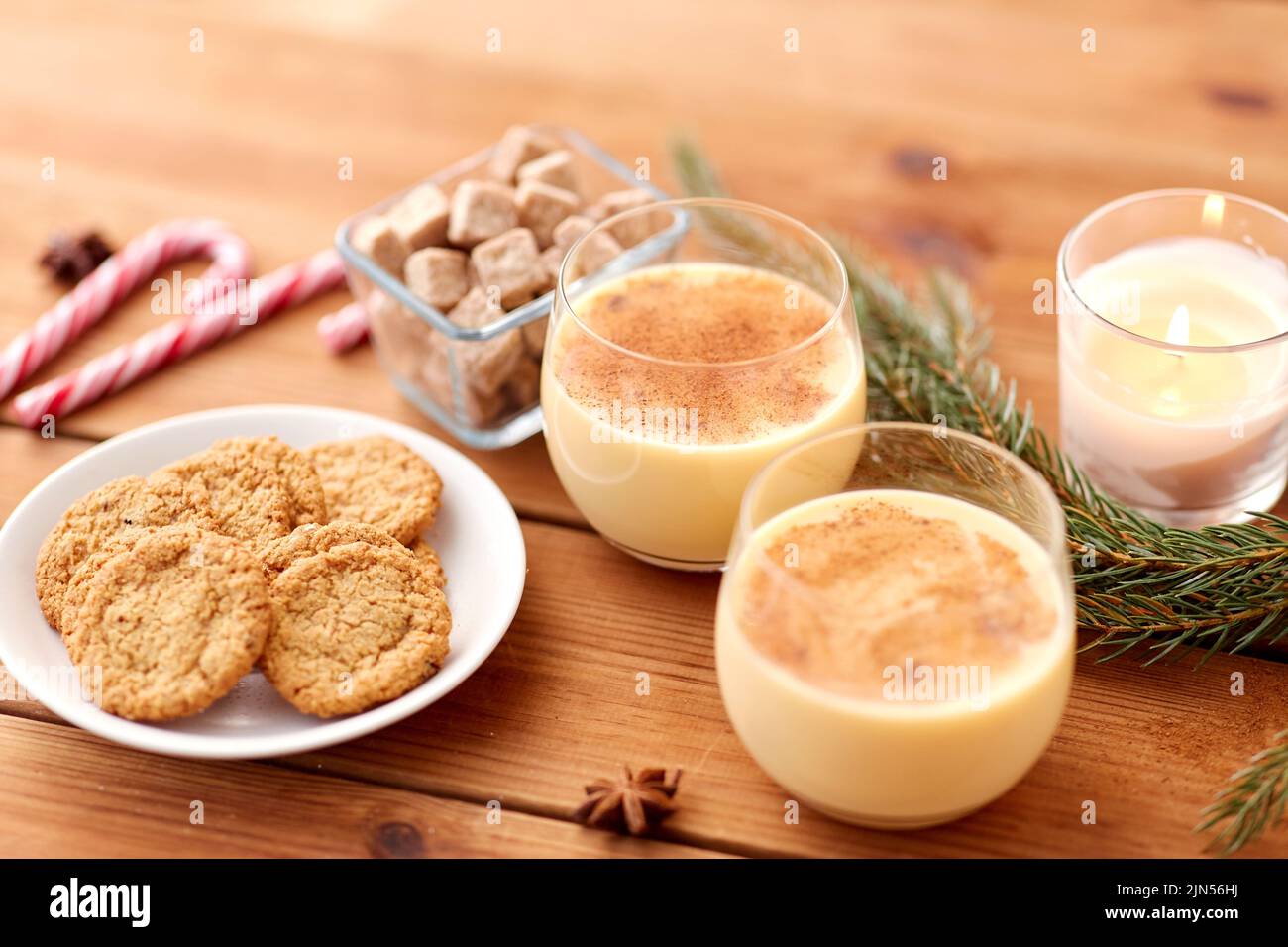 glasses of eggnog, oatmeal cookies and fir branch Stock Photo