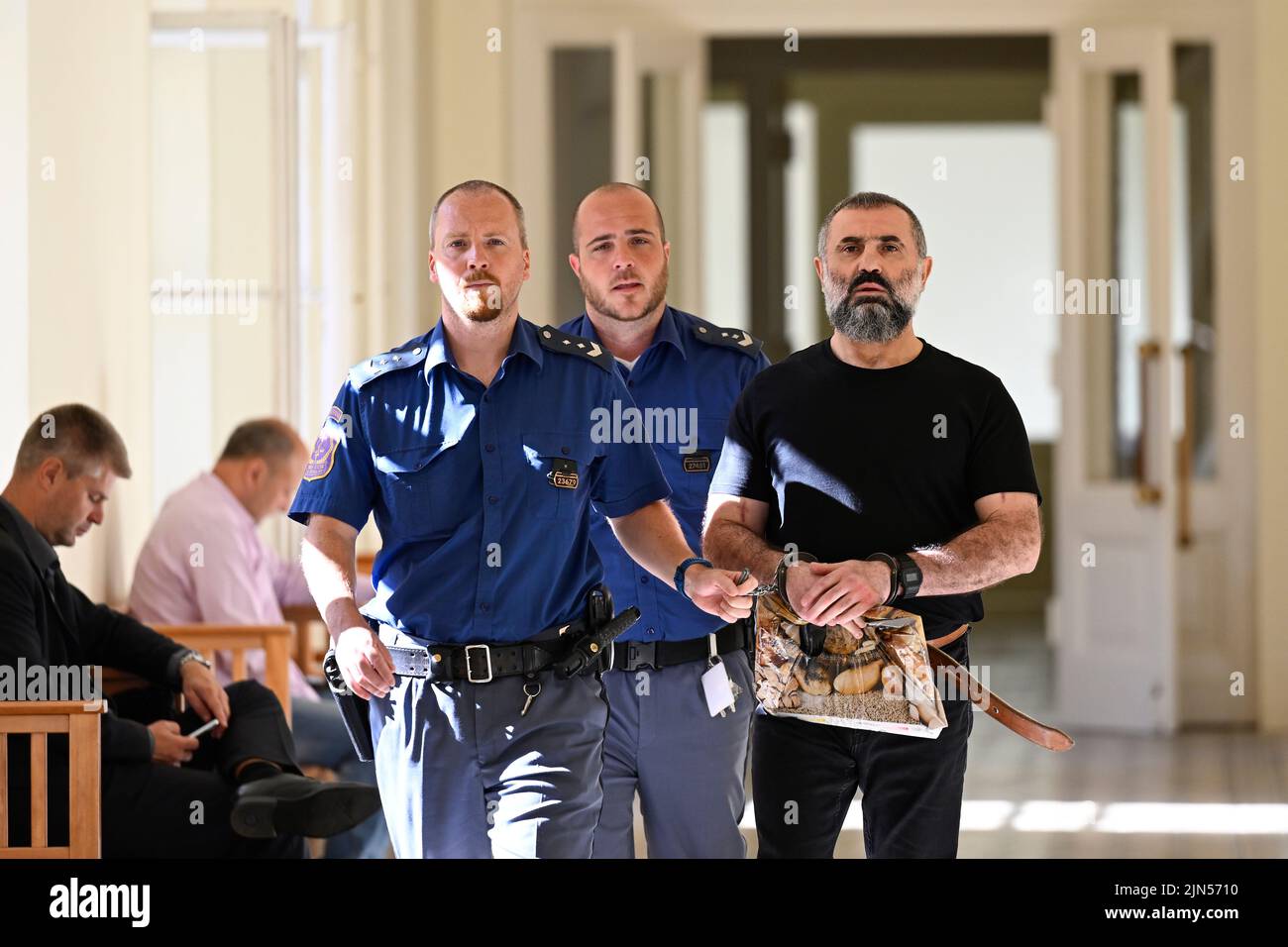 Prague, Czech Republic. 09th Aug, 2022. Armenian Norajr Caturjan, right, comes to the Prague Municipal Court, Czech Republic, on August 9, 2022. Court deals with case of Caturjan charged with shooting at two men outside shopping centre in Prague-Zlicin in 2016, injuring one of them; Caturjan was given 15 years as fugitive and asked for new trial after being detained. Credit: Ondrej Deml/CTK Photo/Alamy Live News Stock Photo