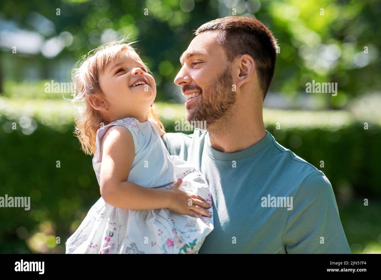 happy father with baby daughter at summer park Stock Photo - Alamy