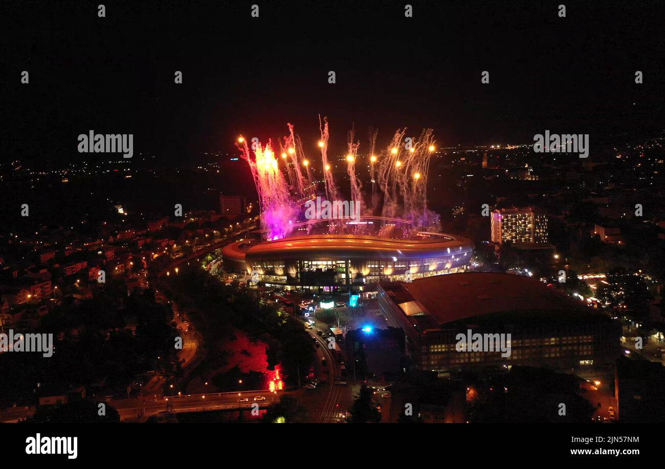 Aerial view of colorful fireworks exploding during night show at New Year's Eve party, 4th of July, music festival. Beautiful cityscape illuminated at Stock Photo
