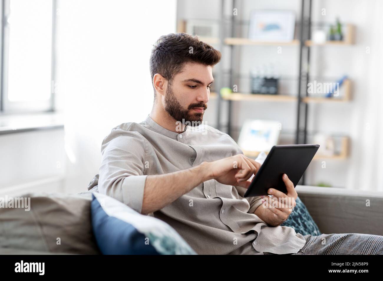 man with tablet computer at home Stock Photo