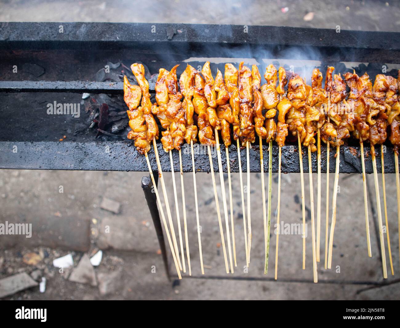 Sate Ayam or Chicken satay, chicken satay in the grilling place with