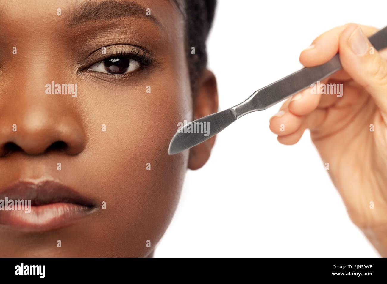 face of african american woman and scalpel knife Stock Photo