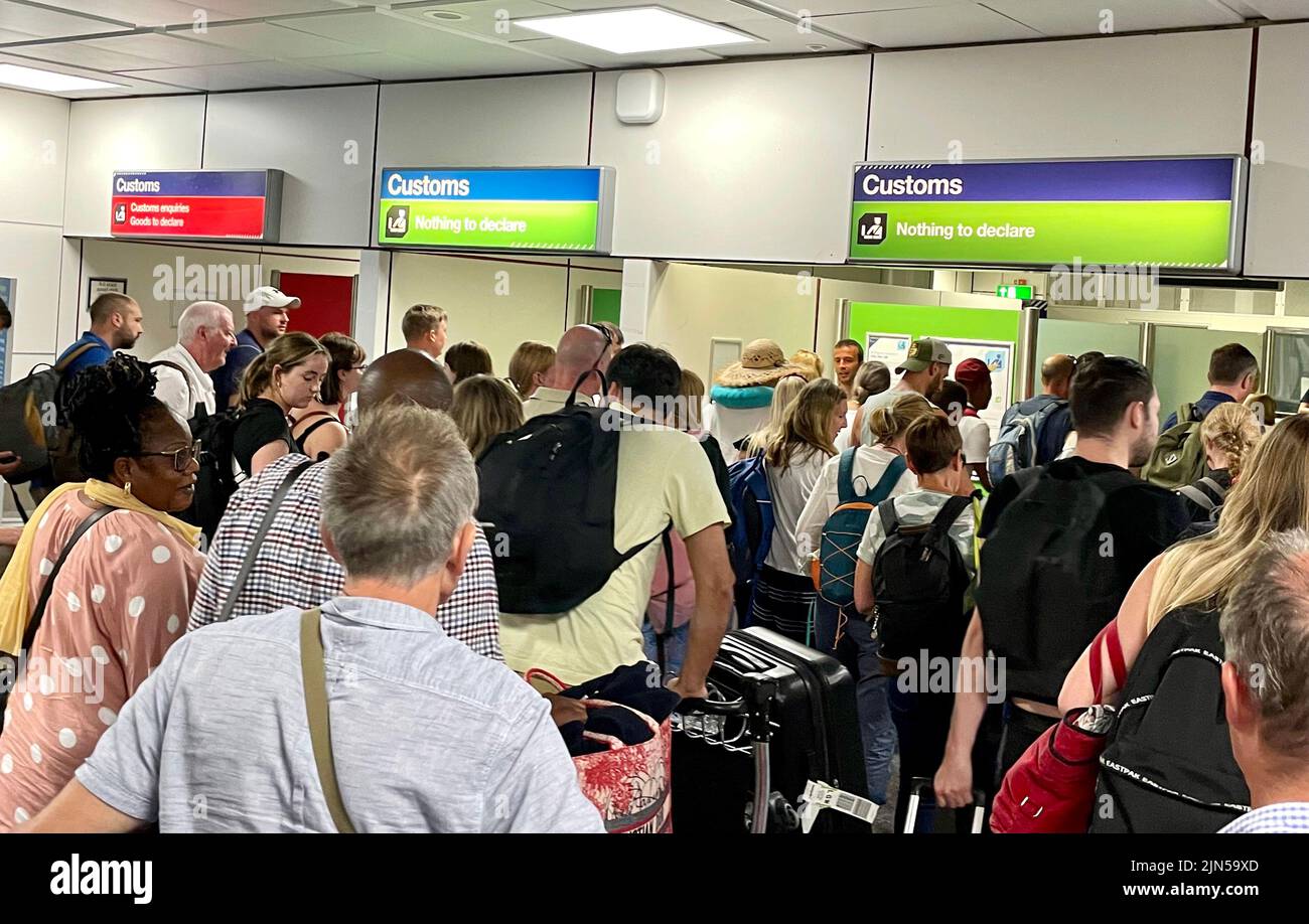 Customs control and Gatwick airport. Passengers arriving are asked to enter through the Red or Green channels. Stock Photo