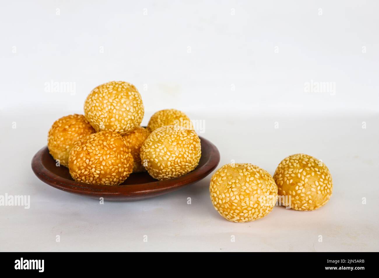 onde-onde or sesame ball or Jian Dui is fried Chinese pastry made from glutinous rice flour and coated with sesame seeds filled with bean paste. Stock Photo