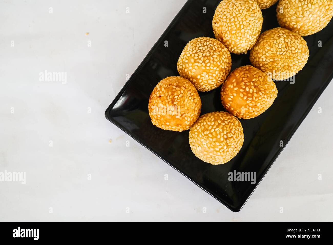 onde-onde or sesame ball or Jian Dui is fried Chinese pastry made from glutinous rice flour and coated with sesame seeds filled with bean paste. Stock Photo