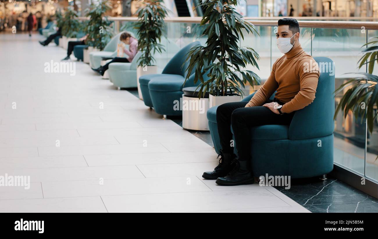 Young indian guy in medical mask protecting health during pandemic