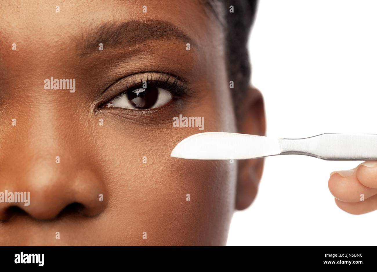 face of african american woman and scalpel knife Stock Photo