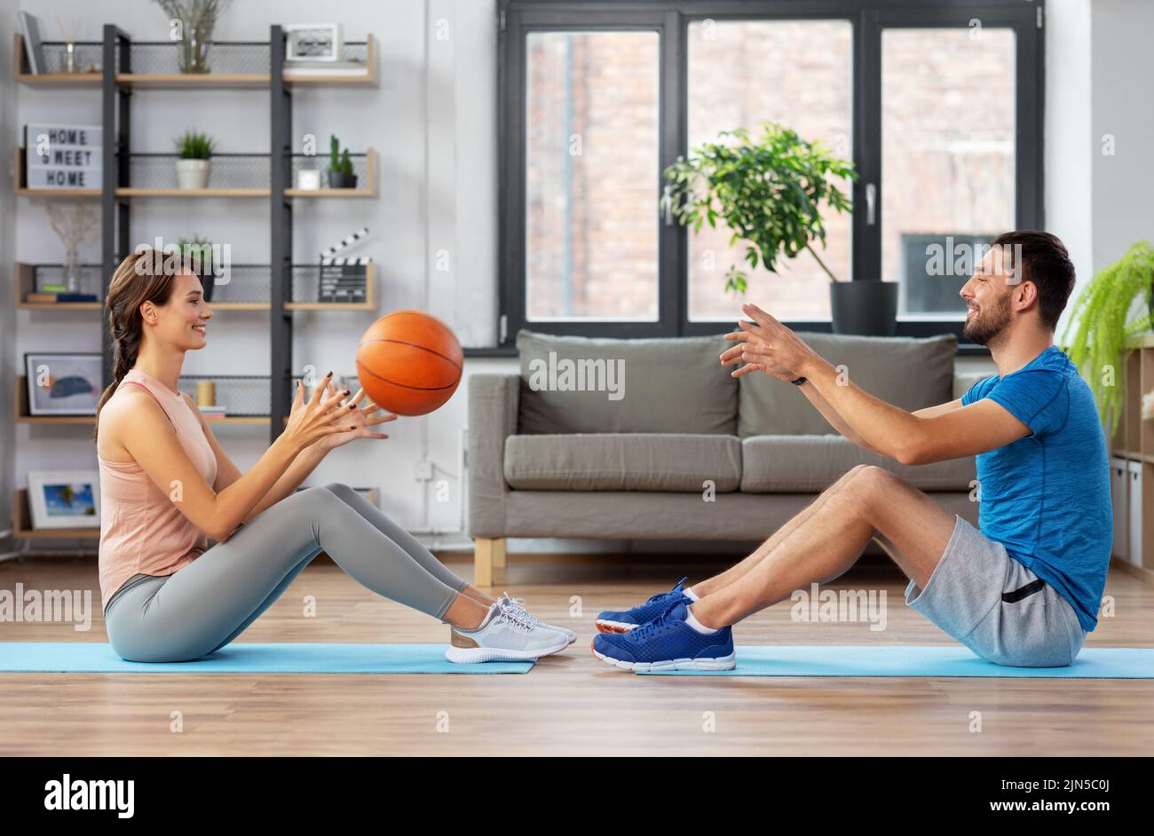 happy couple exercising with ball at home Stock Photo