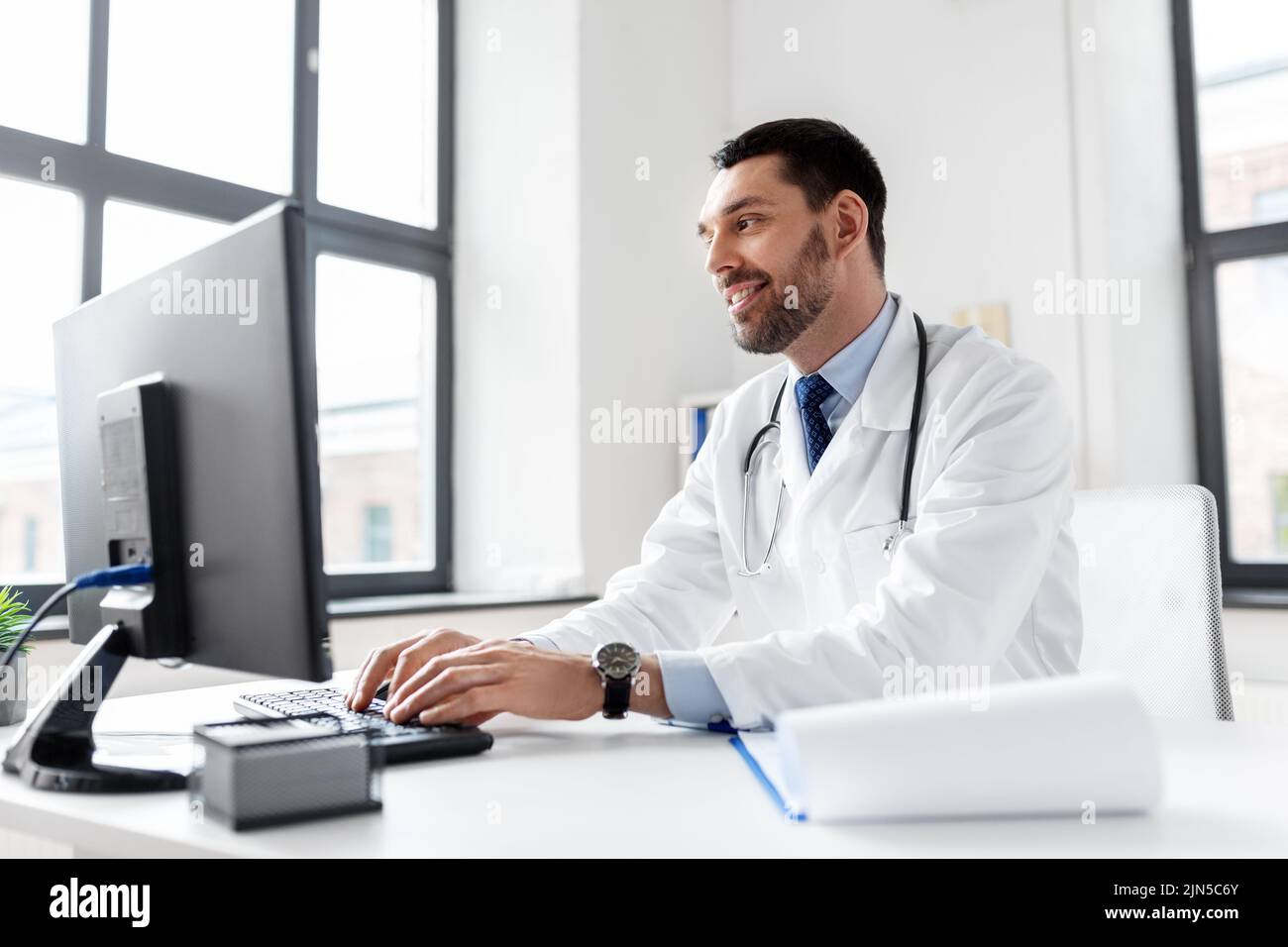 male doctor with computer working at hospital Stock Photo
