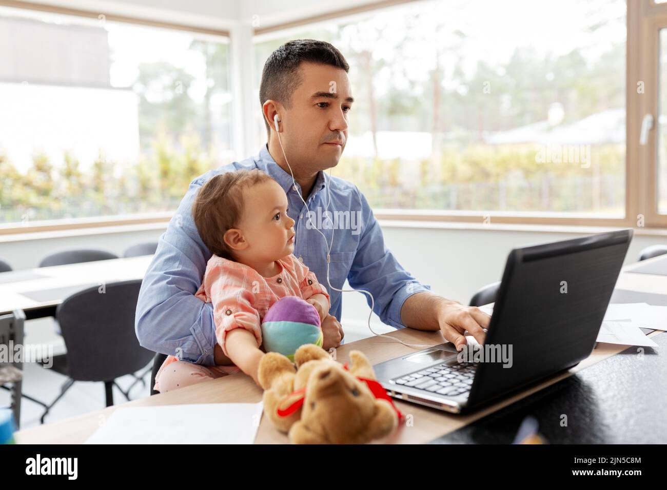 father with baby working at home office Stock Photo