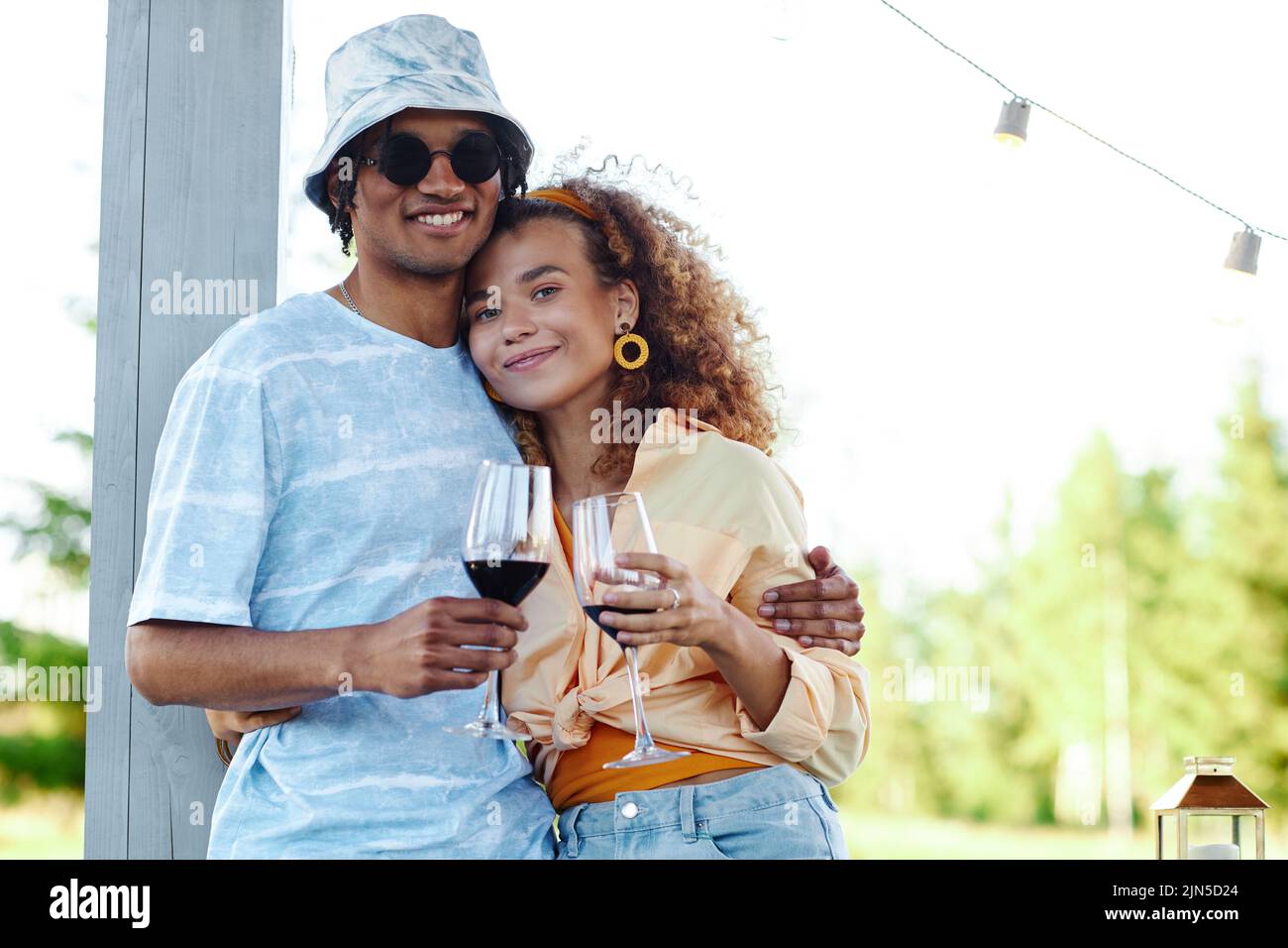 Waist up portrait of young couple embracing outdoors while enjoying romantic date in Summer , copy space Stock Photo