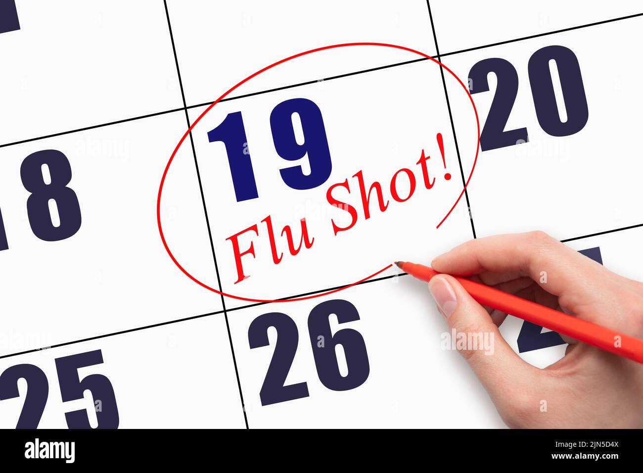 19th day of the month.  Hand writing text FLU SHOT and circling the calendar date. Mark the date on the day planner to have a flu shot. Healthcare Med Stock Photo