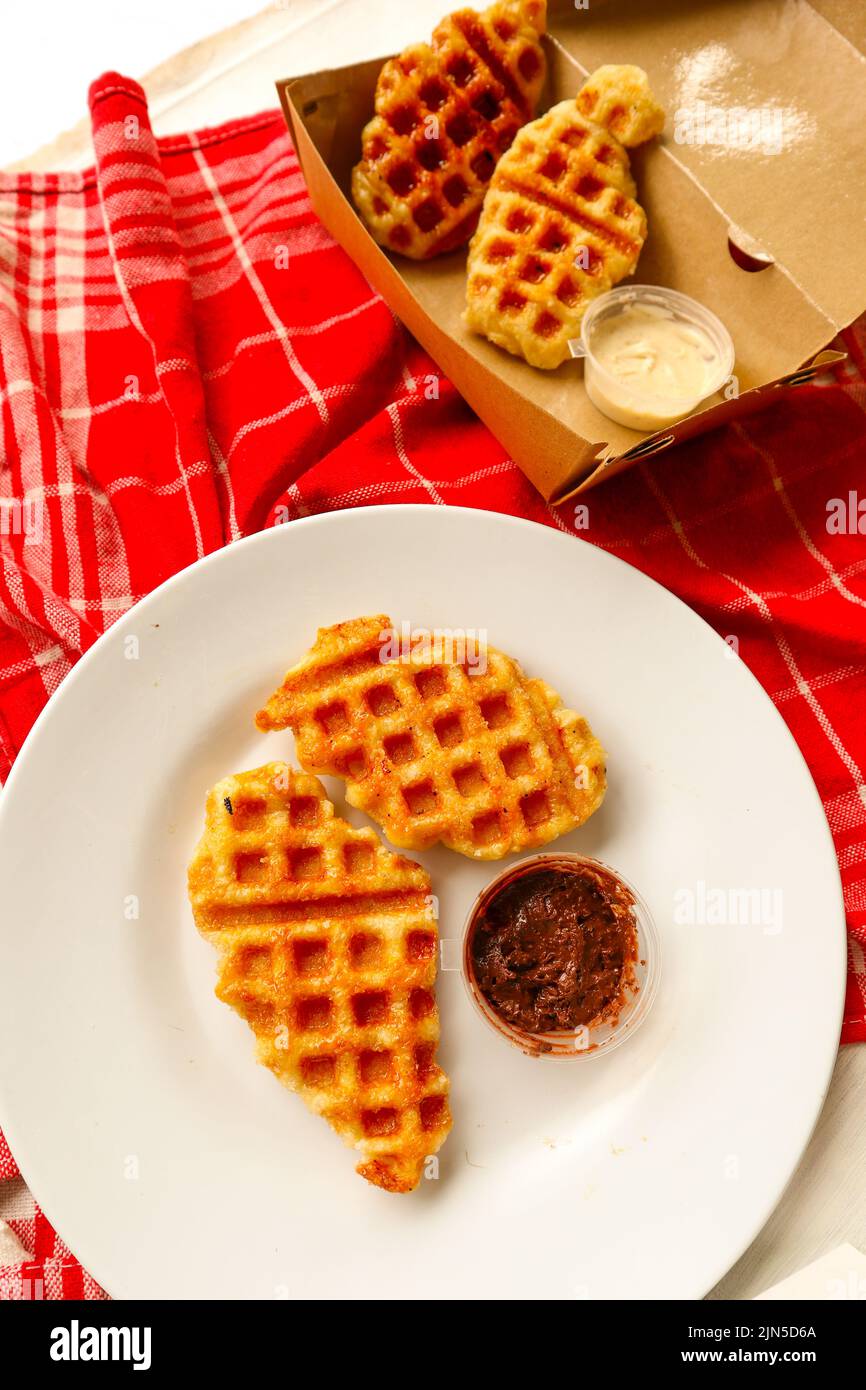 Croissant Waffle or Croffle with chocolate sauce served in box and ...