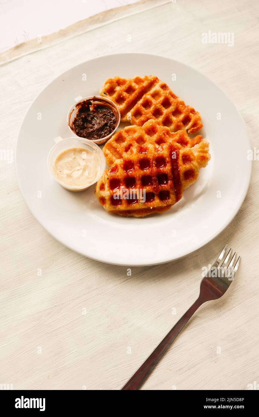 Croissant Waffle or Croffle with chocolate sauce served in box and ...