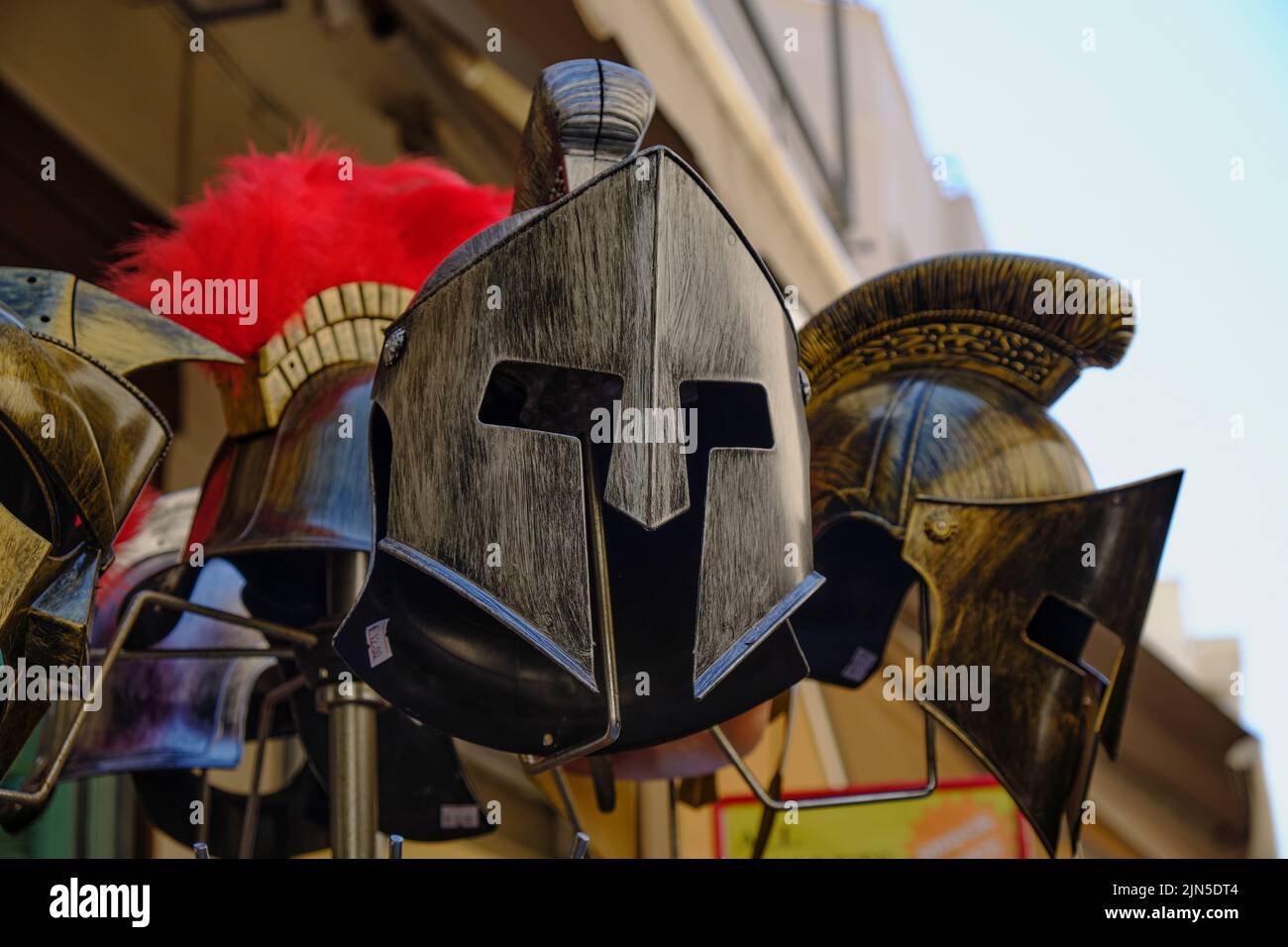 An aray of ancient Greek helmet souvenirs in Athens gift shop Stock Photo