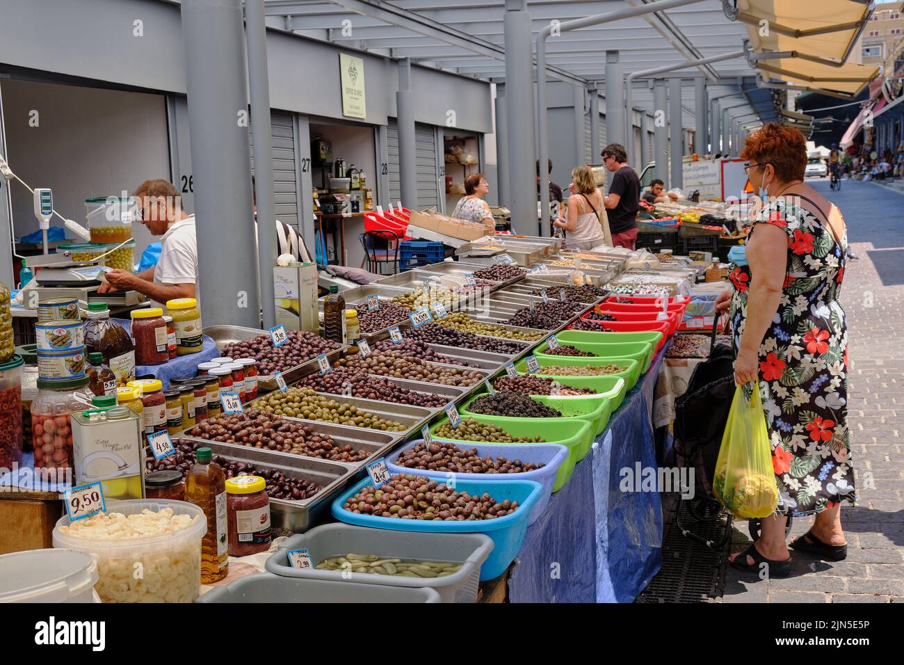 woman buying olives from market stall in Athens Stock Photo