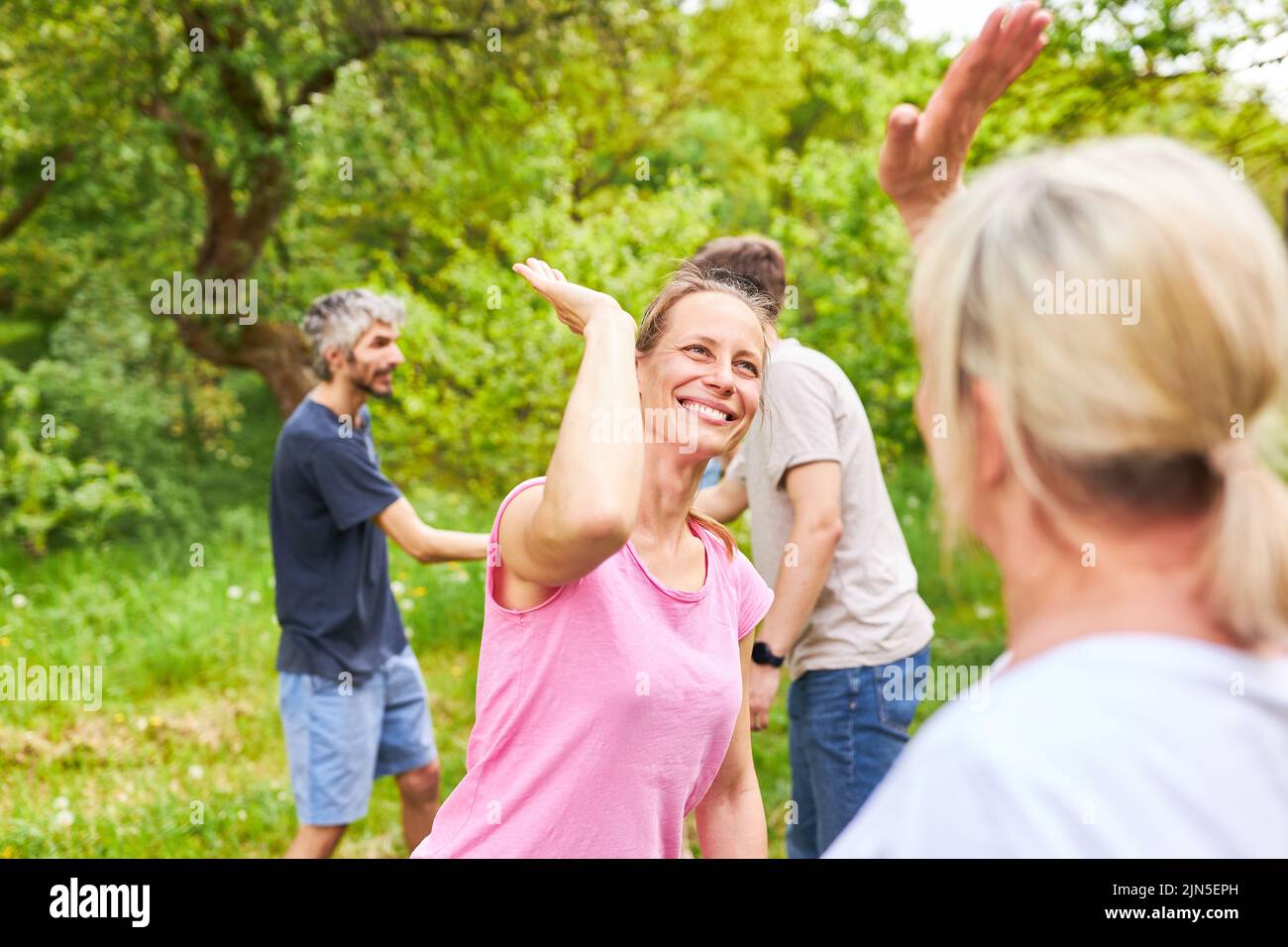 Young people celebrate success in competition by giving high fives or cheering each other on Stock Photo