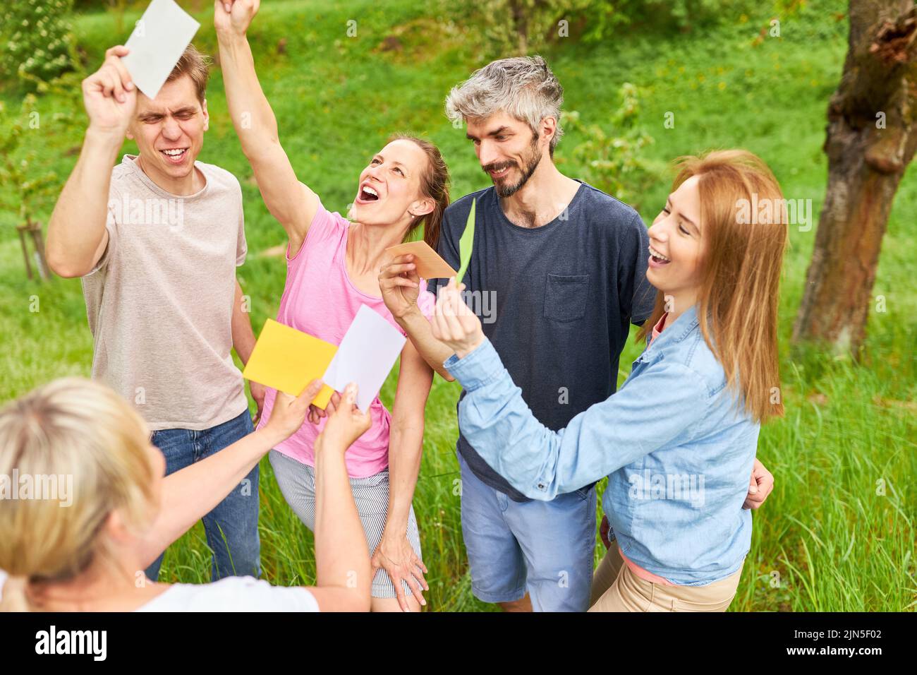 Group of people having fun in creative introductory game in team building workshop Stock Photo