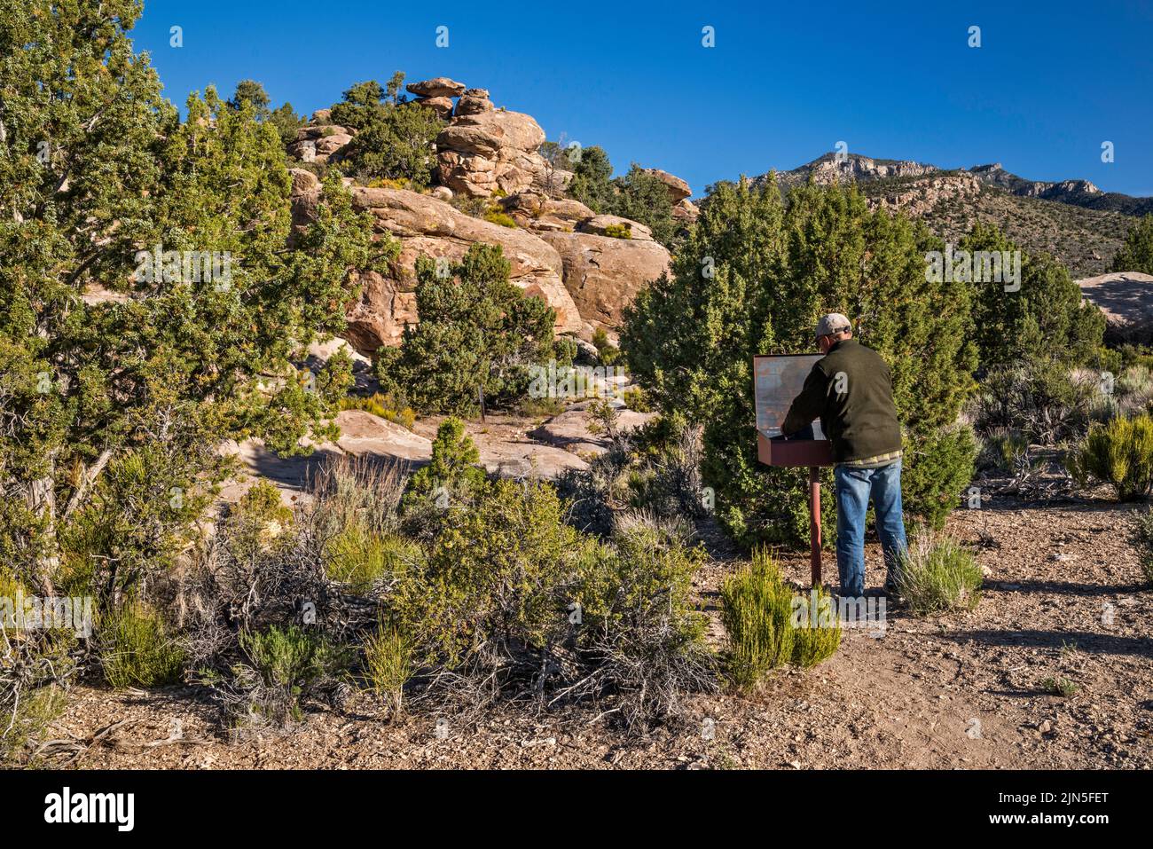 Hiker at register book, Mt Irish Petroglyph Trailhead, Mt Irish Archaeological District, Western Locus, Basin and Range National Monument, Nevada, USA Stock Photo